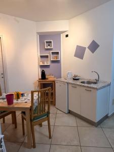 a kitchen with a table and a sink and a table at B&B London 2010 in Vizzola Ticino