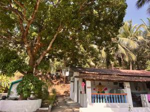 a building with a tree in front of it at The Nivasa Project in Agonda