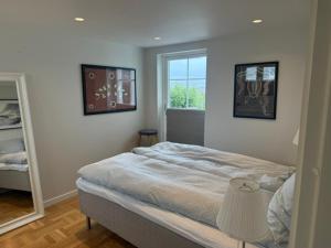 a bedroom with a large bed and a window at Fisketången Seaside Stay in Kungshamn