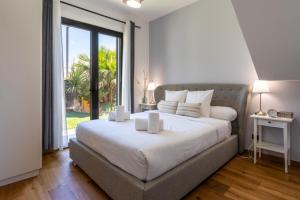 a bedroom with a large bed and a large window at Villa Monégasque elegance & Exclusive seaside getaway in Sérignan