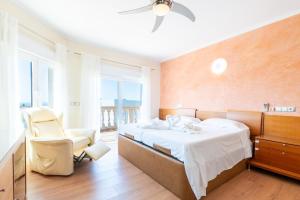 a bedroom with a bed and a chair and a window at Can Martinez in Llucmajor +25 photos