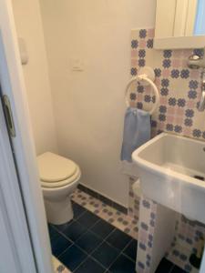 a bathroom with a toilet and a sink at CasaFiumicello in Maratea +6 photos