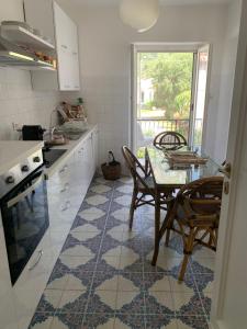 a kitchen with a table and chairs and a dining room at CasaFiumicello in Maratea