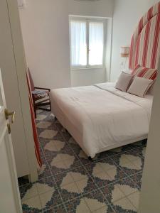 a bedroom with a large bed and a window at CasaFiumicello in Maratea