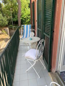a patio with a table and chairs on a balcony at CasaFiumicello in Maratea