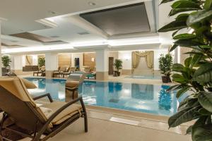 a large swimming pool in a hotel lobby at Hotel Gabriela in Vişeu de Sus