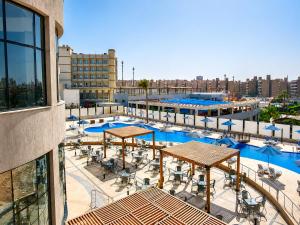 a view of a pool with tables and chairs at Jewel Plaza and Aqua Park in Cairo