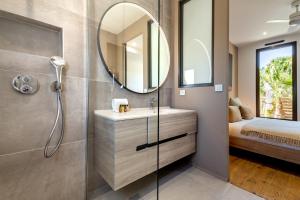 a bathroom with a sink and a mirror at Villa Amphitrite Share beach & happiness in Le Grau-dʼAgde +53 photos