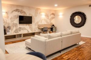 a living room with a couch and a flat screen tv at Hotel Escuela Santa Cruz in Santa Cruz de Tenerife