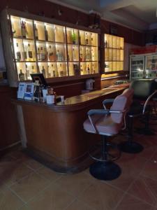 a bar with two chairs and a counter in a room at Inn Lucky in Jomtien Beach