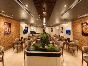 a restaurant with tables and chairs in a room at Jewel Plaza and Aqua Park in Cairo