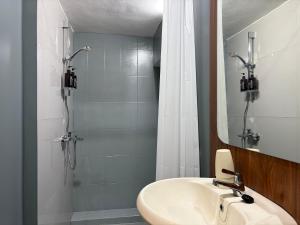 a bathroom with a sink and a shower at Altha Stay Cokro in Ngabean +45 photos