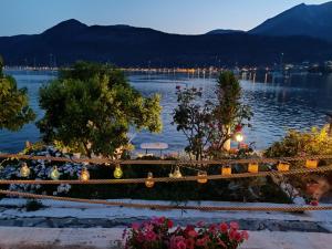 a view of a body of water with trees and flowers at Geni Bay 2 in Lefkada