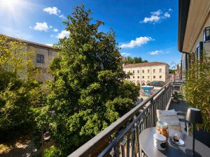 a balcony with a tree and a table with coffee on it at Camera con Vista in Cervia