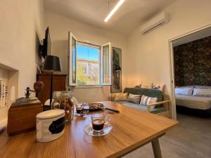 a living room with a wooden table and a couch at Camera con Vista in Cervia