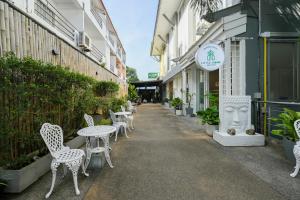a row of tables and chairs outside of a building at Little Home Ao Nang in Ao Nang Beach