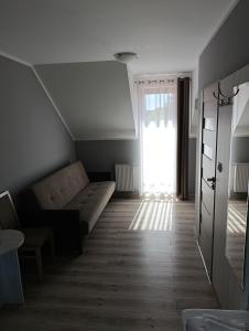 a living room with a couch and a window at Biovilla in Stobnicko +7 photos