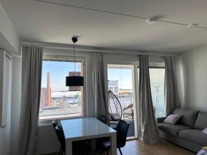 a living room with a table and a couch at Onnellinen Koti in Vaasa
