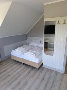 a bedroom with a bed and a large mirror at Biovilla in Stobnicko