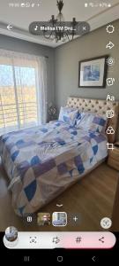 a bedroom with a bed with a blue and white comforter at Mansouria beach resort in Mohammedia