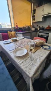 a table in a kitchen with a glass of wine at Mansouria beach resort in Mohammedia