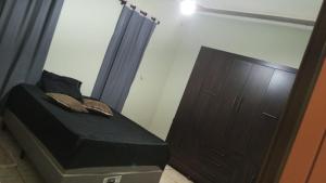 a small bedroom with a bed and a dresser at Quarto casal standart max in Ribeirão Preto +3 photos