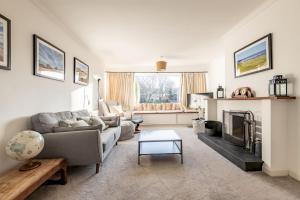 a living room with a couch and a fireplace at Kingsmuir - Elie in Earlsferry