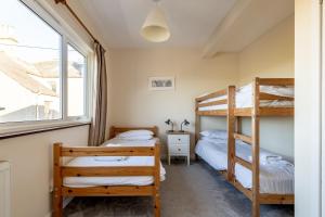 two bunk beds in a room with a window at Kingsmuir - Elie in Earlsferry