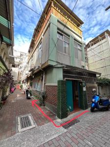 a scooter parked in front of a building at HouseNandoor in Tainan