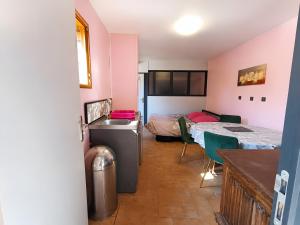 a room with a bed and a table and chairs at Gite 5 Pers proche Wimereux in Belle-et-Houllefort