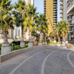 a street in a city with palm trees and buildings at Sea View Tower - 33rd Floor l Parking l Mamad in Bat Yam
