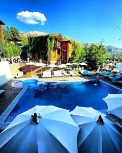 a swimming pool with umbrellas in a resort at Nebesa Hotel EZ in Chimgan +9 photos