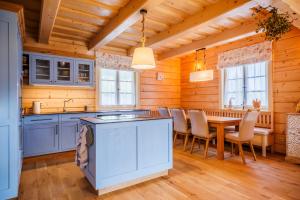 a kitchen with a table and chairs in a room at Roubenka Pod Oblohou in Dolní Morava