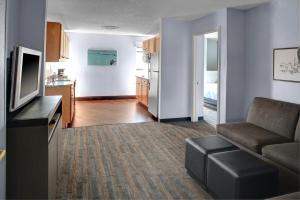 a living room with a couch and a television at Hyatt House Dallas Uptown in Dallas