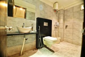 a bathroom with a sink and a toilet at Bless Inn in Prayagraj