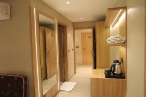 a hotel room with a bathroom with a mirror at Sai Krishna Hill View Resort in Pawārkhera