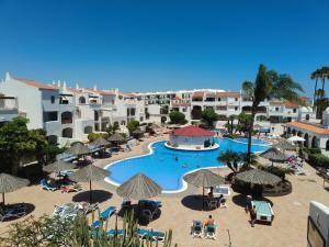 an aerial view of a resort pool with umbrellas at FAIRWAYS CLUB, suite B37 in San Miguel de Abona