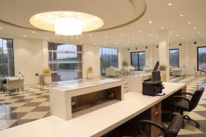 an office lobby with a reception desk and chairs at Sai Krishna Hill View Resort in Pawārkhera +23 photos