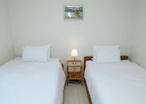 two beds sitting next to each other in a room at Fresh Stay in Seoul