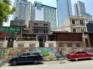 two cars parked in a parking lot in a city at Hotel Arba in Kuala Lumpur