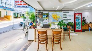 a restaurant with a table and chairs and a map at Cat Ba Violet Hotel and Apartment in Cat Ba +113 photos