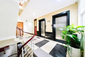 a hallway with black doors and potted plants at Cat Ba Violet Hotel and Apartment in Cat Ba