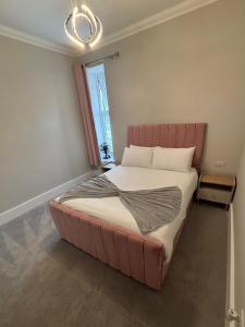 a large bed in a room with a window at Raasay Apartment in Fort William