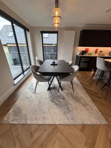 a dining table and chairs in a living room at Raasay Apartment in Fort William +8 photos