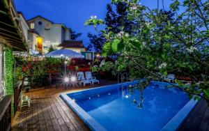 a swimming pool in a yard with chairs and trees at Taean like the first time pension in Taean +11 photos