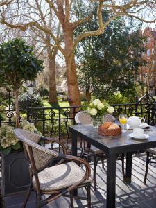 a black table and chairs on a patio at Collingham Serviced Apartments in London
