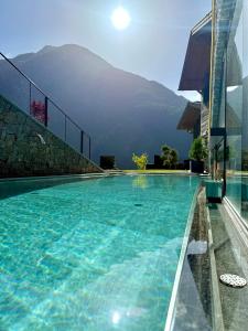 a swimming pool with a view of a mountain at The Peak Sölden - Chalets mit Outdoor-Pool in Sölden