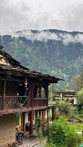 a house with a view of a mountain at Heritage hut in Vashisht