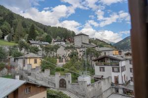 a view of a town with buildings and mountains at B&B Vecchio Borgo in Bormio +43 photos