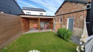 a backyard with a yard with a table and chairs at La P'tite Brique in Rochefort